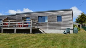 A modern two-story house with a deck, a covered outdoor area, and a small garden. -  Sea view with terrace and garden for hiking, sailing, beach ... (Crozon)