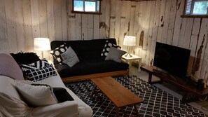 Flat-screen TV, fireplace, books