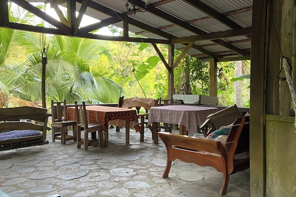 Multiple hammocks, couches to sit while enjoiying breeze and sound of river
