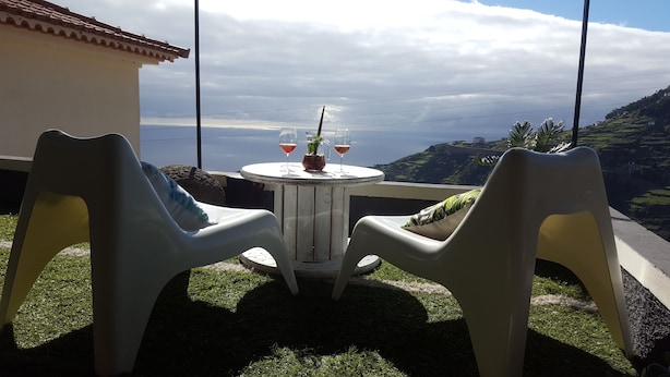 A table with two chairs and a pitcher of drinks, overlooking a coastal landscape. - Fantastic - Cabo Girão view  (Câmara de Lobos)