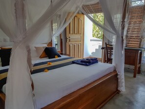 A bedroom with a wooden bed, white bedding, and a canopy. - White Villa Beach Resort (Thalaramba)