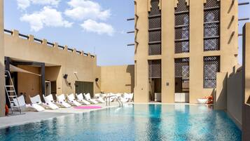 Outdoor pool, pool loungers, lifeguards on site