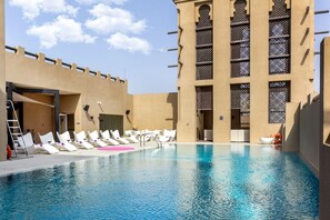 Outdoor pool, pool loungers, lifeguards on site - Premier Inn Dubai Al Jaddaf (Dubai)