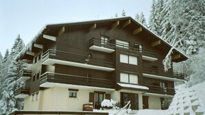 A multi-story chalet with balconies, a ski lift, and snow-covered trees. - Quiet rental with view of Mont Blanc - 4 people  (Saint-Gervais-Les-Bains)