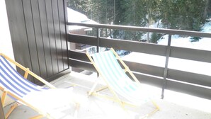 A balcony with two striped beach chairs and a view of a snowy landscape. - Quiet rental with view of Mont Blanc - 4 people  (Saint-Gervais-Les-Bains)