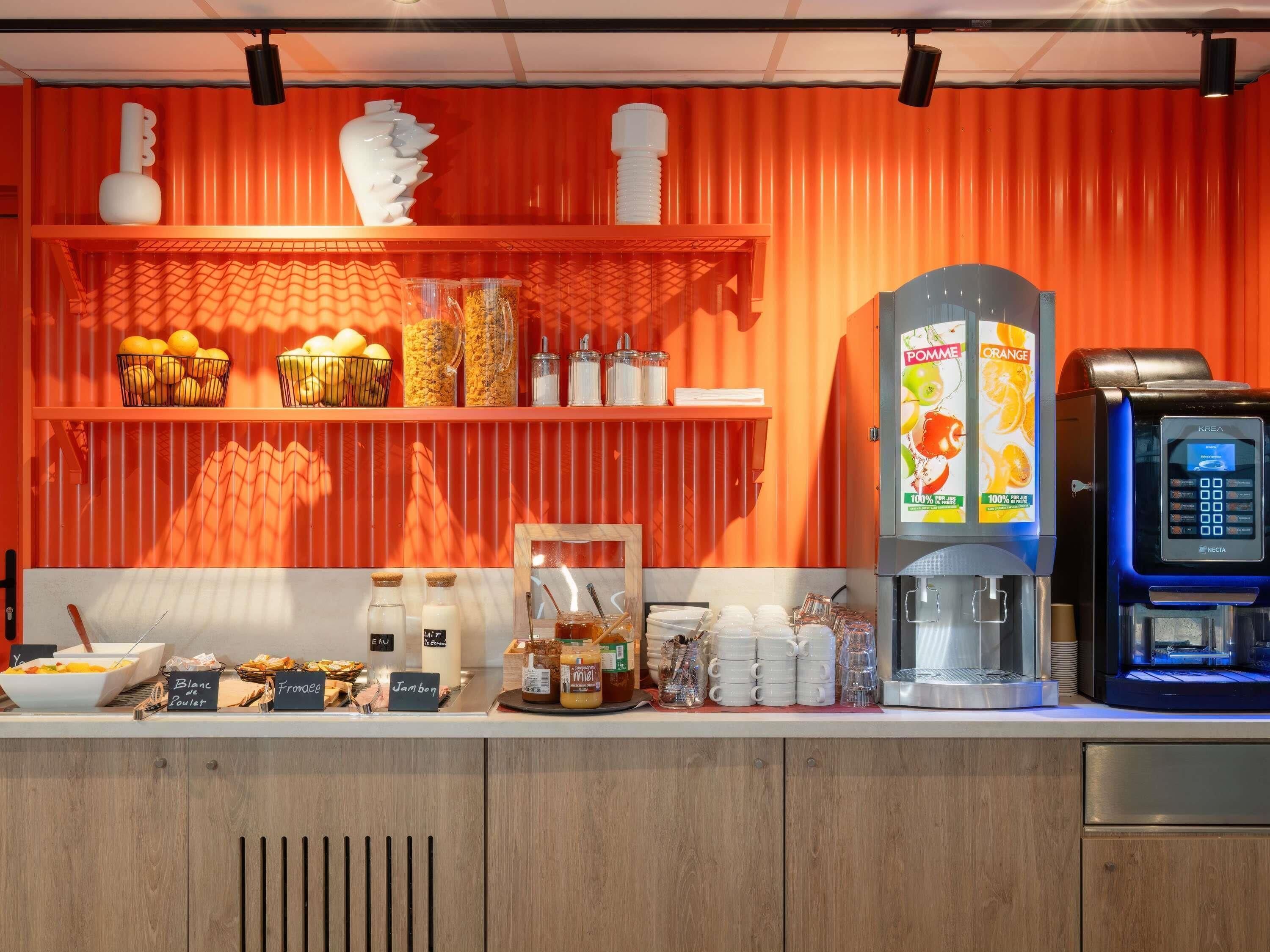 A breakfast bar with various food items and a coffee machine.