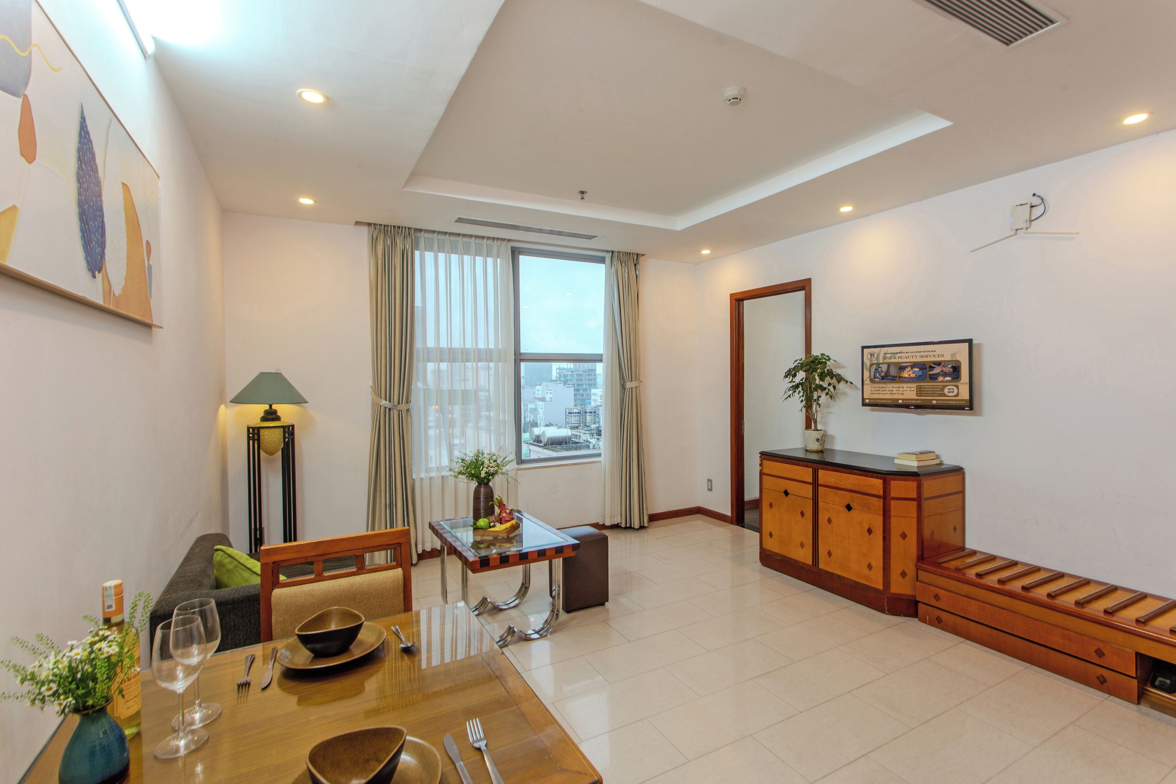 A modern living room with a dining area, a sofa, a table with chairs, a lamp, and a large window with curtains.