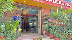 A hotel entrance with a sign reading "HOTEL READERS IN" and "Sambhu Marg Airport Kathmandu, Nepal". - Hotel Readers Inn Pvt.Ltd (Kathmandu)