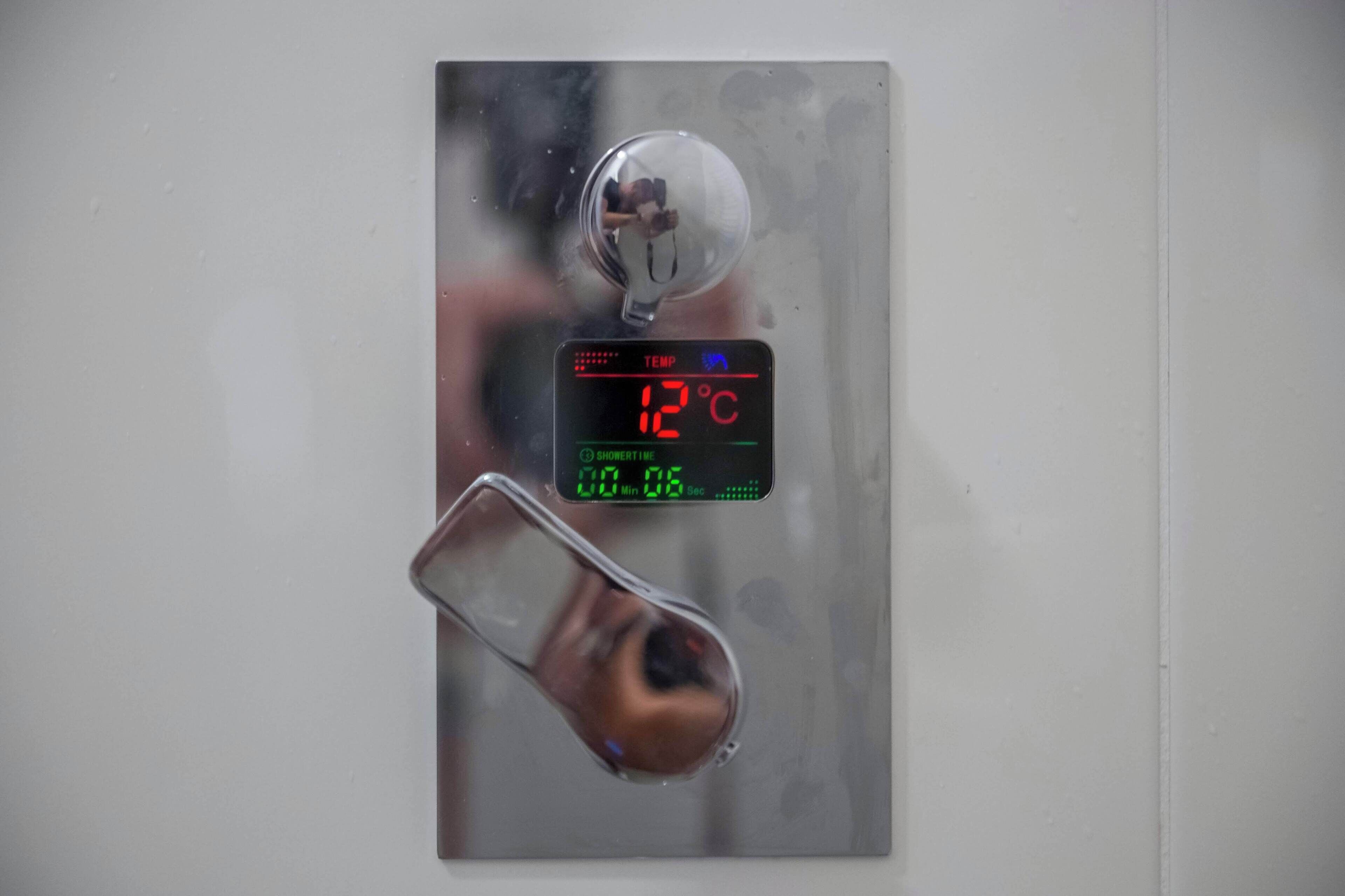 A digital thermometer displaying 12°C.