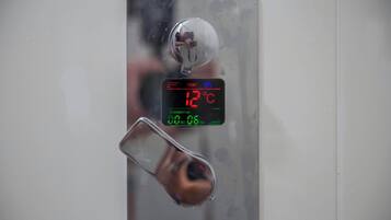 A digital thermometer displaying 12°C.