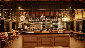 A spacious restaurant with high ceilings, exposed beams, and a central bar area. - Hotel Labaris Khao Yai (Pak Chong)