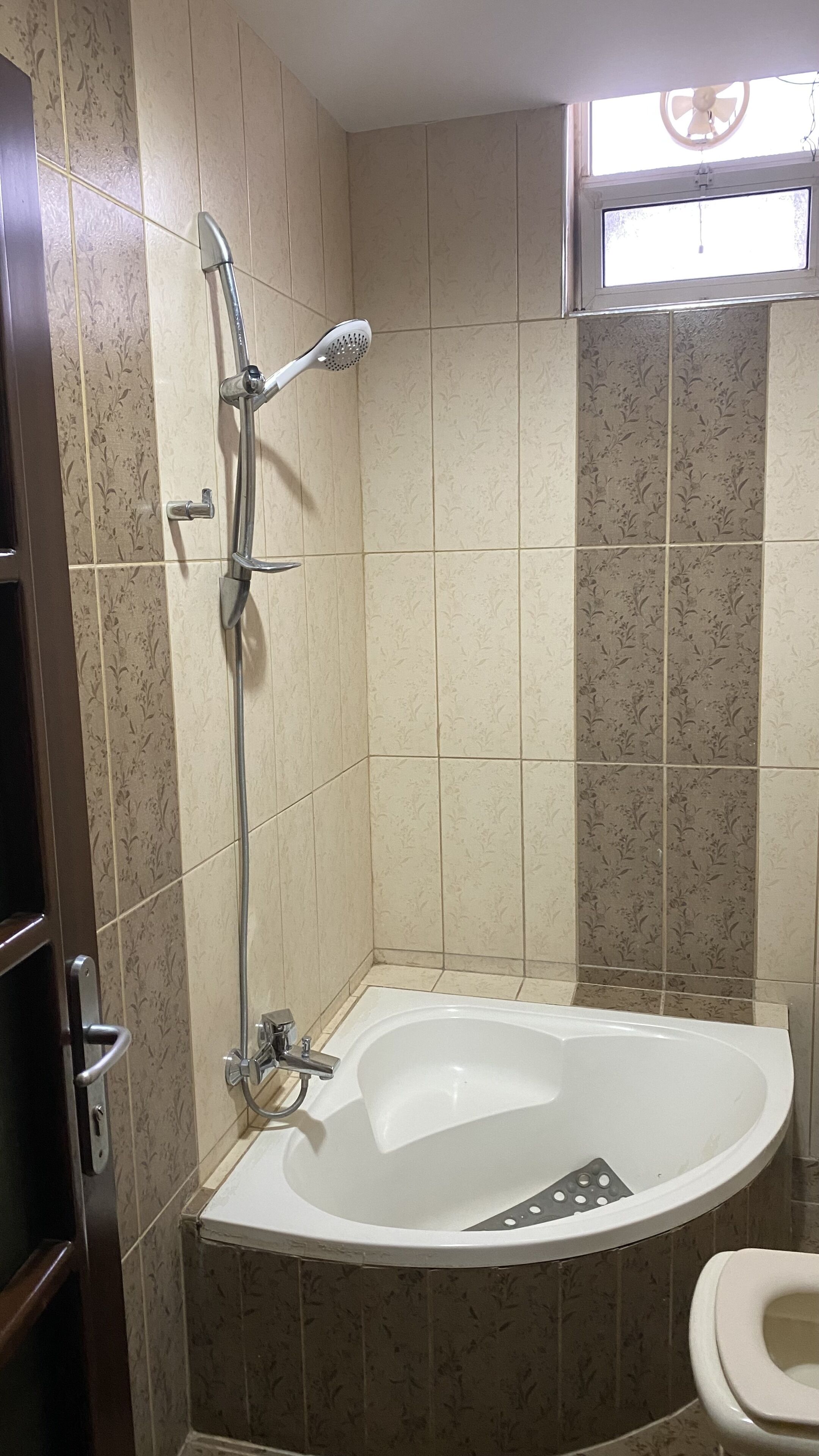 A bathroom with a bathtub, a shower, and a toilet.