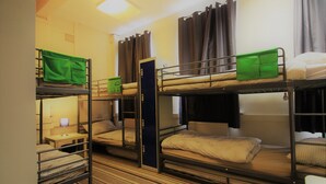 A dormitory-style room with bunk beds, a desk, and a chair. - Hull Trinity Backpackers (Hull)