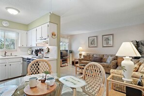 Open dining and living area with a bright coastal feel and convenient access to the kitchen.