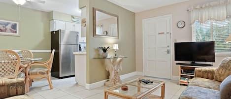 Spacious living area with comfortable seating, TV, and easy access to the kitchen and dining area.