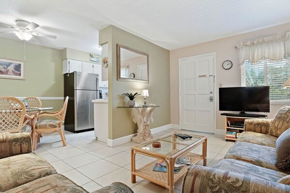 Spacious living area with comfortable seating, TV, and easy access to the kitchen and dining area.
