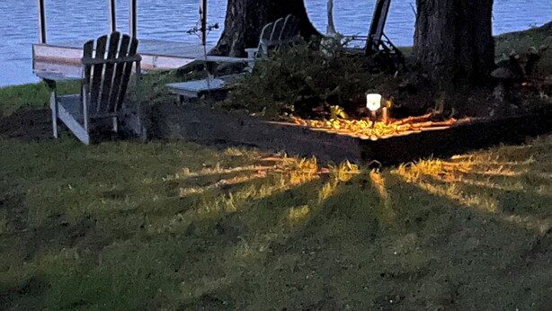 A lakeside setting with a dock, chairs, and a campfire. - Waterfront Home with Stunning Views .. Dog friendly , and great fishing !!! (Douglas)