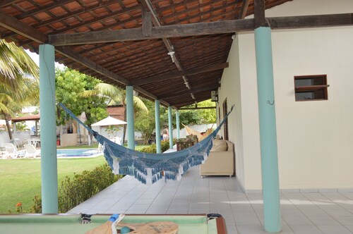 Beach house with leisure area and deserted beach with natural pools.