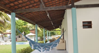 Beach house with leisure area and deserted beach with natural pools.