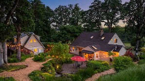 A two-story house with a covered patio and a red umbrella. - Go BeyOnd Ordinary & Escape to this Magnificent Wine Country Retreat, Golf, Hot Tub, Close to PDX (West Linn)