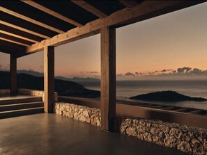 An open-air structure with stone walls and wooden beams, overlooking a coastal landscape. - Luxury villa with private pool and amazing sea view (Αγ. Νικόλαος, βολίμες, Ζάκυνθος)