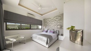 A modern bedroom with a bed, bedside table, and a unique wall decoration.