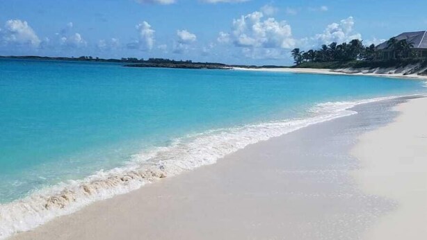 A beach with clear turquoise water, white sand, and a few scattered clouds. - As seen on HGTV's Bahamas Life - Perfect Villa for an Island Getaway! (Paradise Island, Nassau)