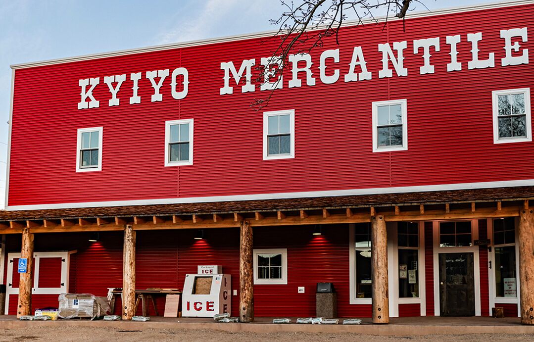 A red building with the sign "KIYIO MERCANTILE" on the facade.