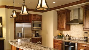 A kitchen with wooden cabinets, stainless steel appliances, a granite countertop, and pendant lighting. - New Listing!! Ritz-Carlton At Vail Lion's Head Village!  Luxurious ski vacation! (Vail)