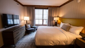 A hotel room with a large bed, a television, a desk with a lamp, and a chair. - New Listing!! Ritz-Carlton At Vail Lion's Head Village!  Luxurious ski vacation! (Vail)