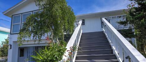 A two-story building with a staircase leading to the entrance.