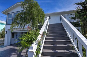 A two-story building with a staircase leading to the entrance.