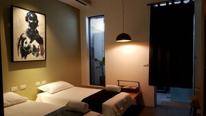A hotel room with two beds, a large abstract painting, a window with blinds, a bedside table with a lamp, and a view of the outside. - Sweethome37 (New Taipei City)