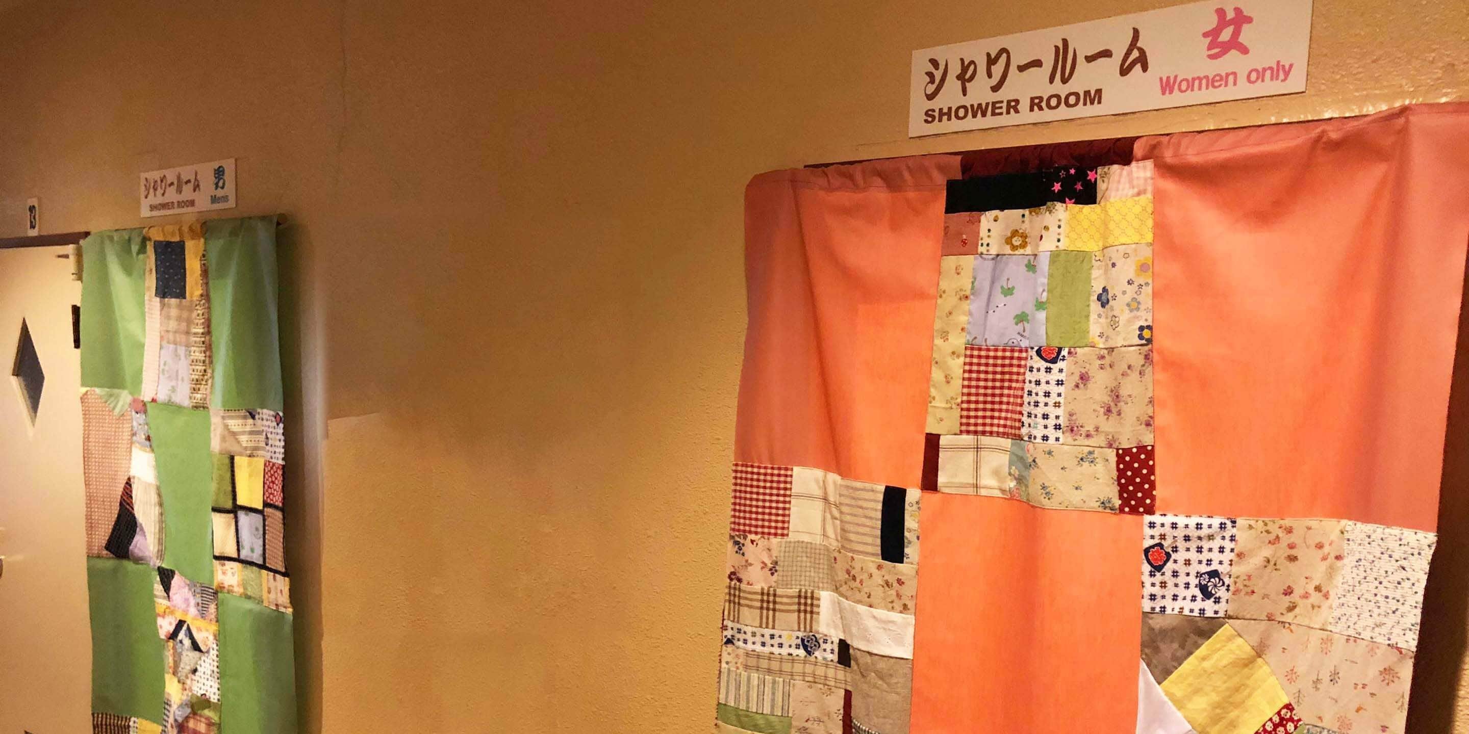 A women's shower room with a sign indicating it is for women only.