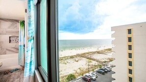 A room with a view of a beach and parking area. - Beautiful direct Gulf view & beach front condo. (Gulf Shores)