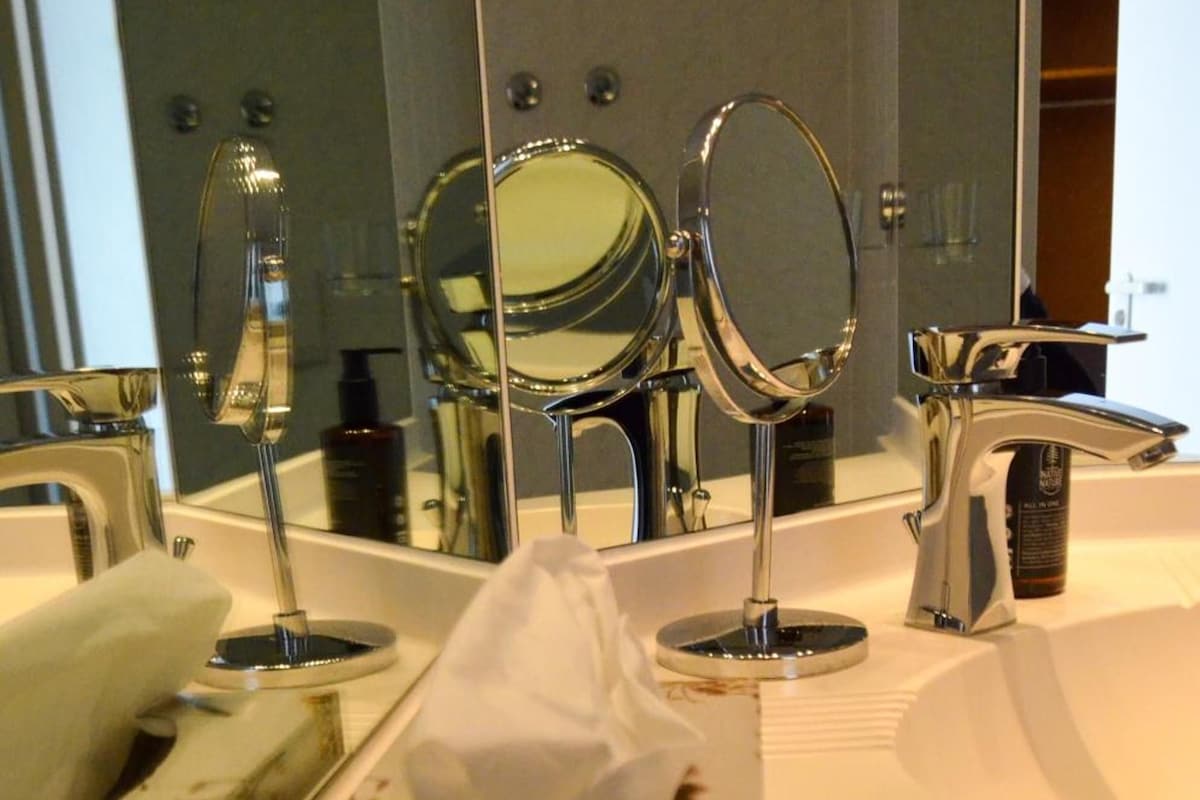 A bathroom with a mirror, a towel, and a tissue box.