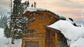 A wooden cabin with a snow-covered roof, surrounded by snow-covered trees and mountains. - Luxury On Mountain Ski Accommodation located between Alta and Snowbird (Alta)