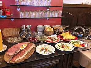 A buffet with various food items and condiments.