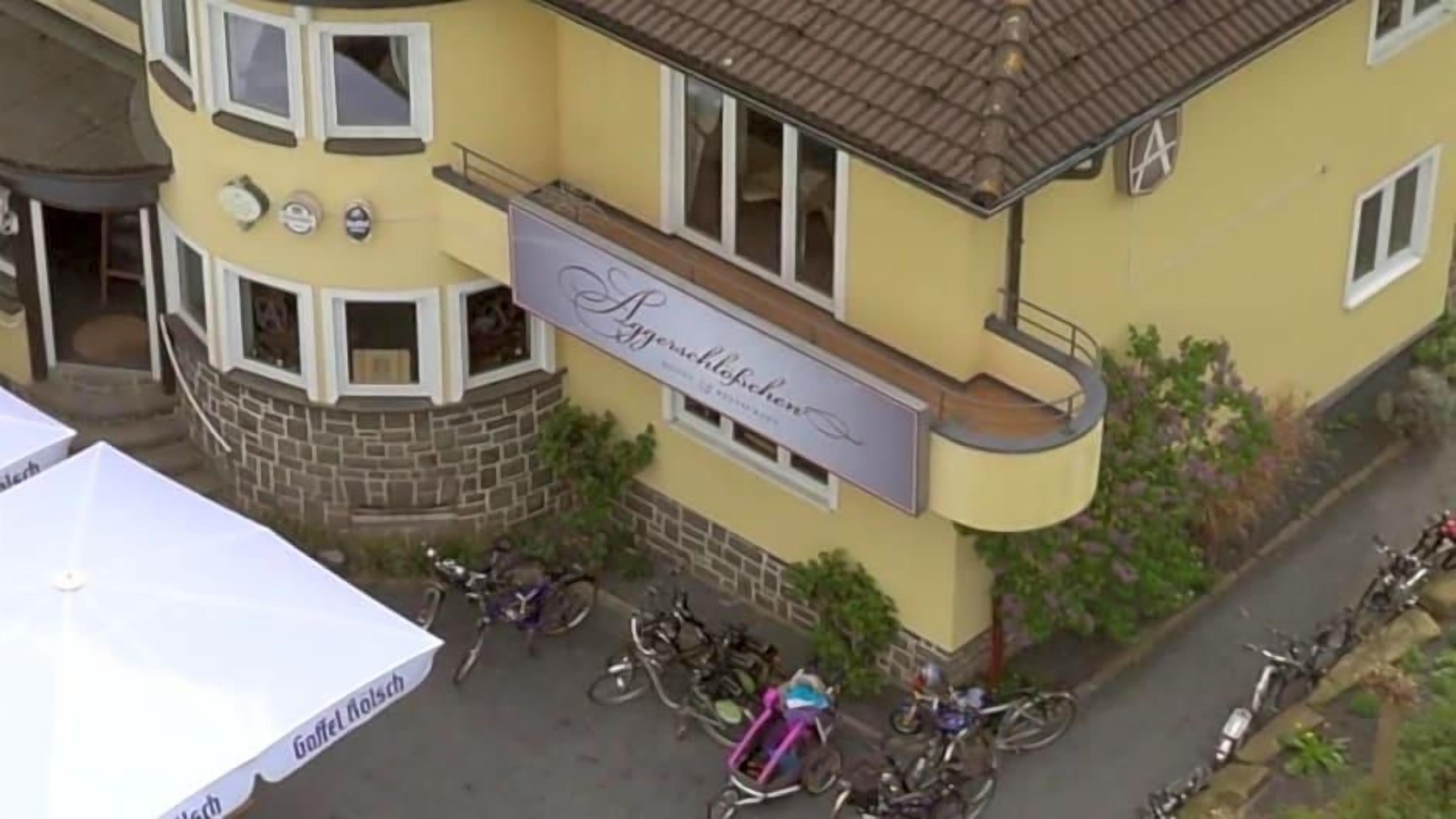 A building with a sign that reads 'Spezialrestaurant.' There are bicycles parked in front.