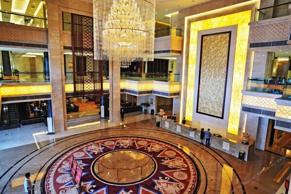 A spacious lobby with a central circular design, a chandelier, and a reception desk. - Guest Hotel of Luohe (Luohe)