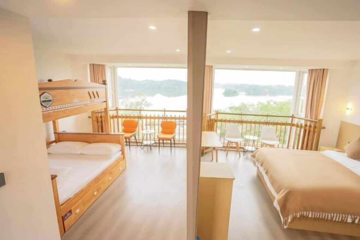 Een hotelkamer met balkon, een bed, een bureau en een stoel.
