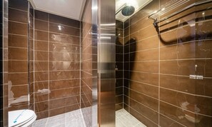A bathroom with a toilet, a shower, and a bathtub.