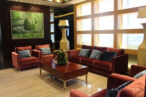 A modern living room with a sectional sofa, armchairs, and a coffee table.