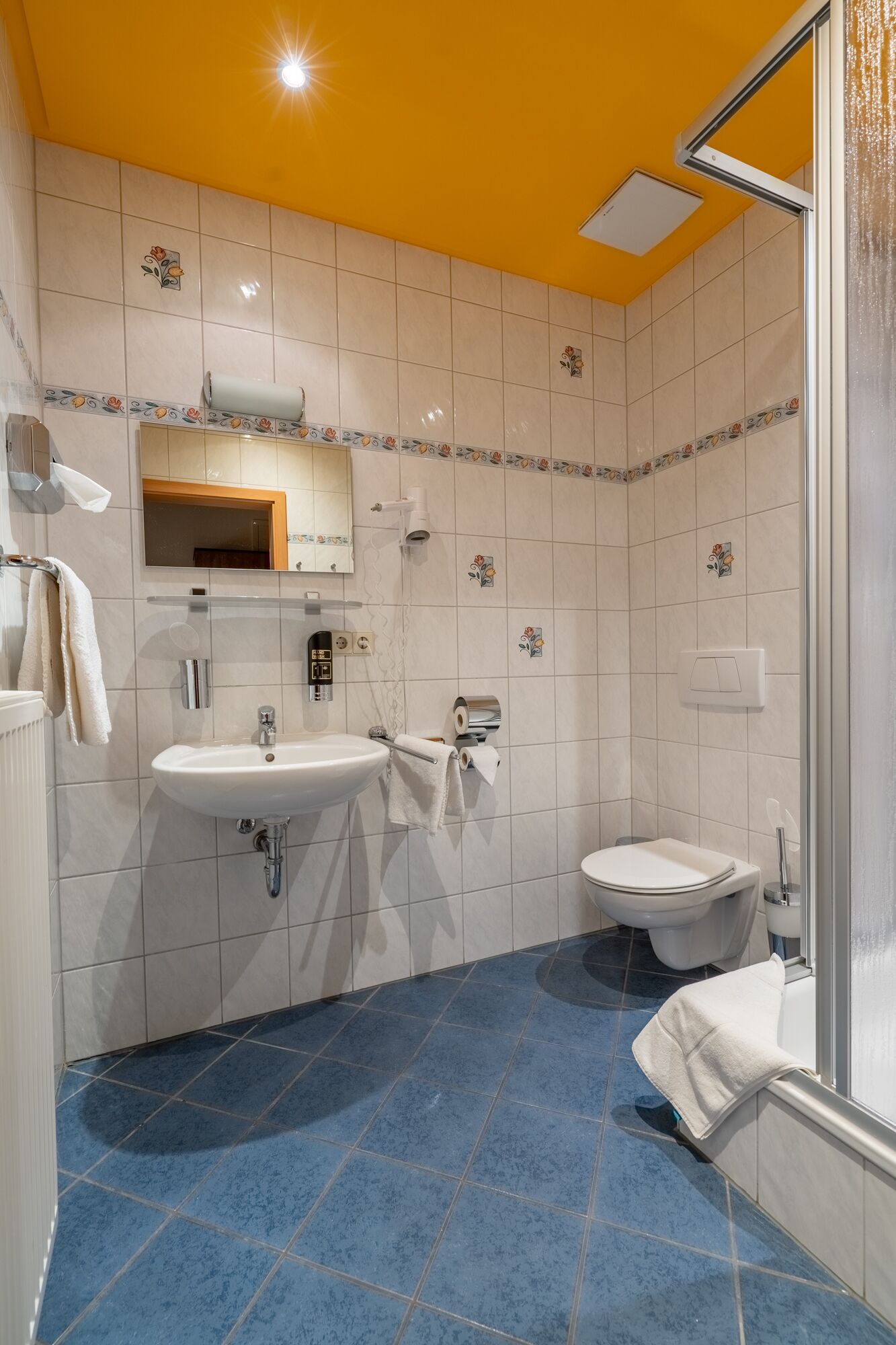 A bathroom with a sink, toilet, and shower.