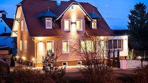 A two-story house with a sloped roof, multiple windows, and a visible chimney. - Birkenfelder Hof (Birkenfeld)