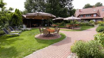 A patio area with outdoor seating and a brick pathway.