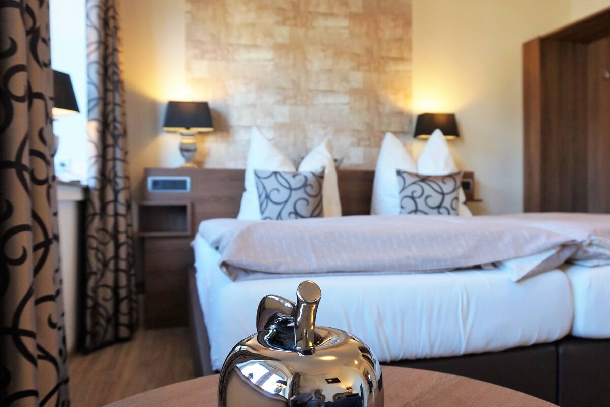 Premium bedding, desk, laptop workspace, blackout drapes