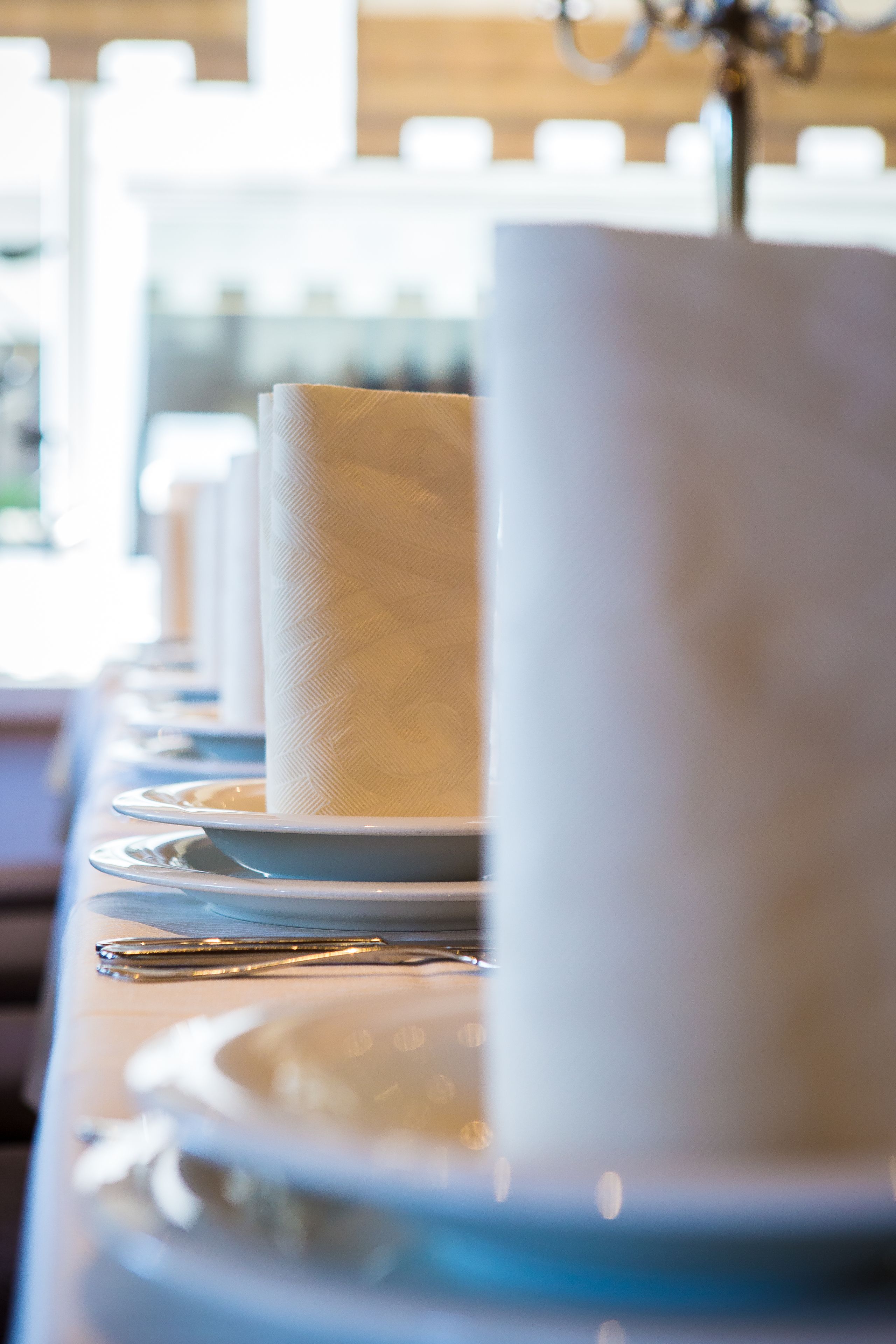 A table set with plates, napkins, and cutlery.