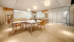 A conference room with multiple tables, chairs, and a whiteboard. - Hotel Restaurant Reuter (Rheda-Wiedenbruck)