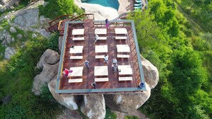 An outdoor deck with multiple seating areas overlooking a natural landscape. - Seronera Wildlife Lodge (Serengeti)